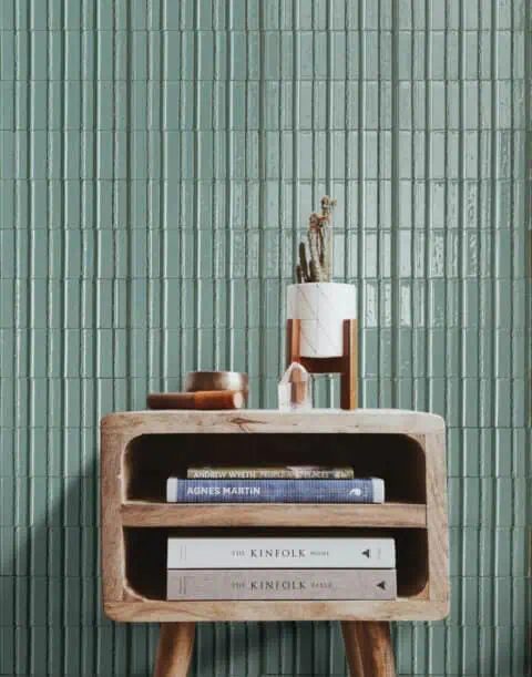 Wall of slim glazed green tiles laid vertically